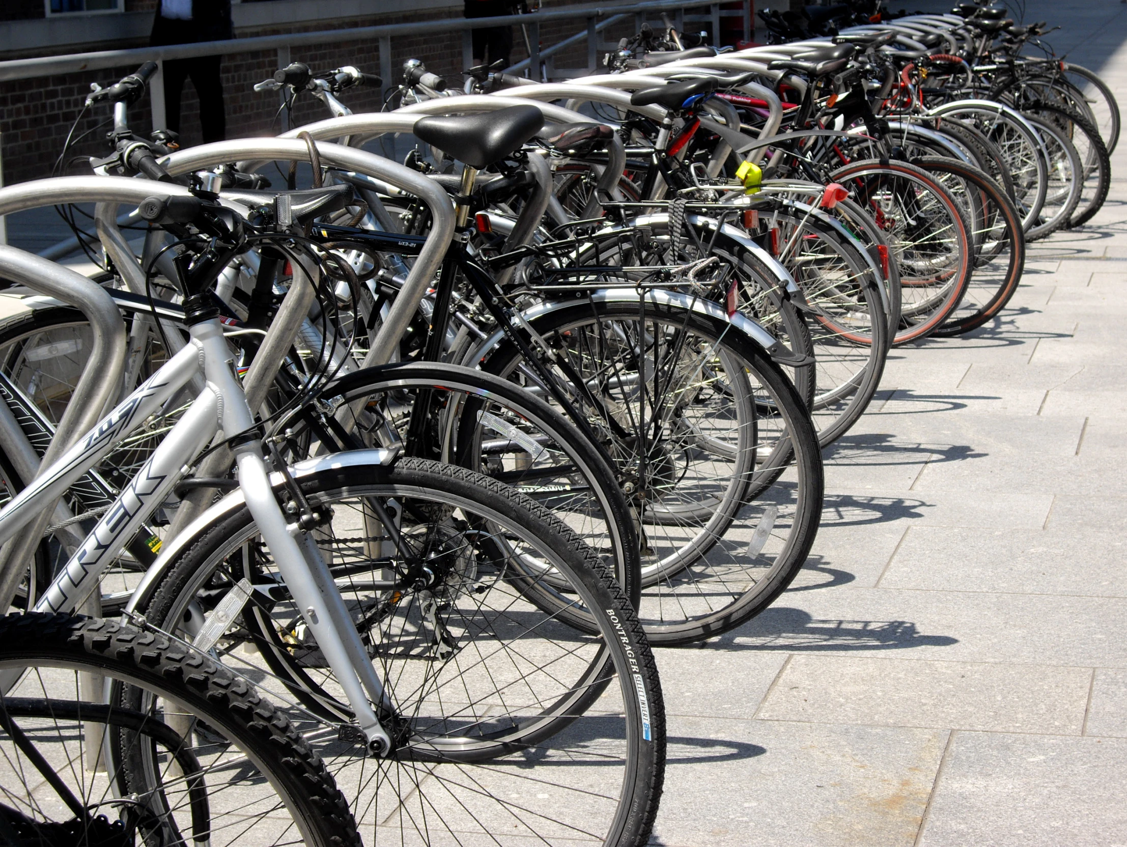 a row of bikes parked next to each other on the side of a road