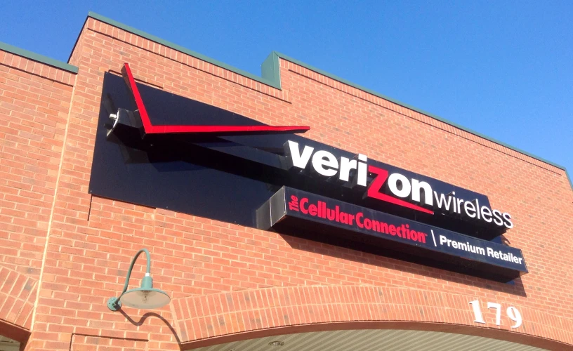 the brick building has a sign for verizon wireless