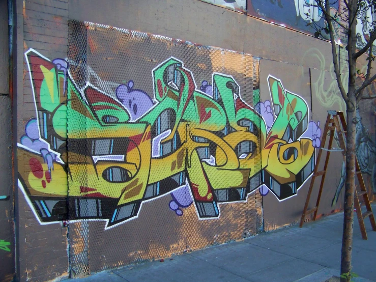 an image of a bunch of graffiti writing on the side of a building