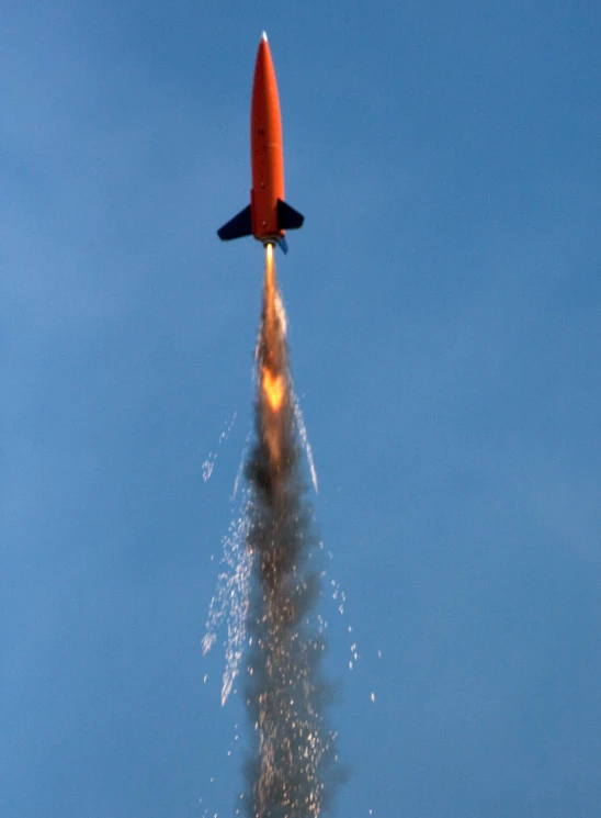 a jet airplane releasing fire in the sky