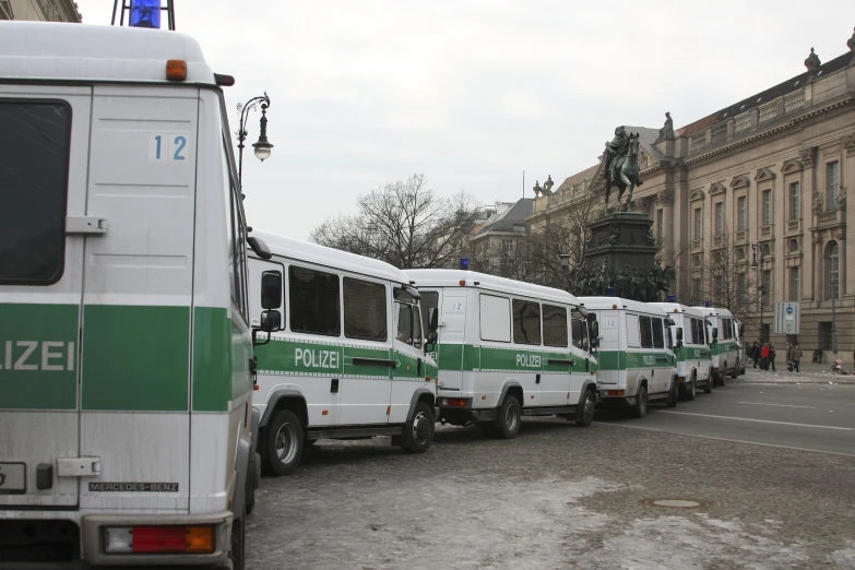 a line of parked buses in a city