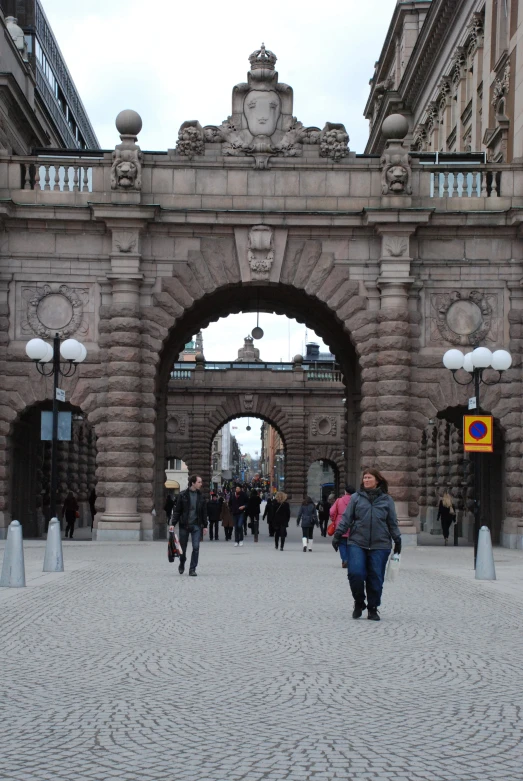 a couple of people that are walking near a building