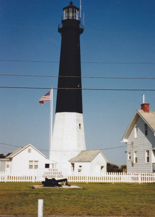 a lighthouse with a flag flying over it