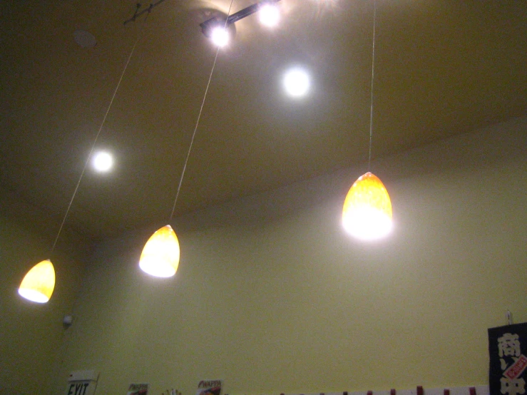 a ceiling with several hanging lights and decorations