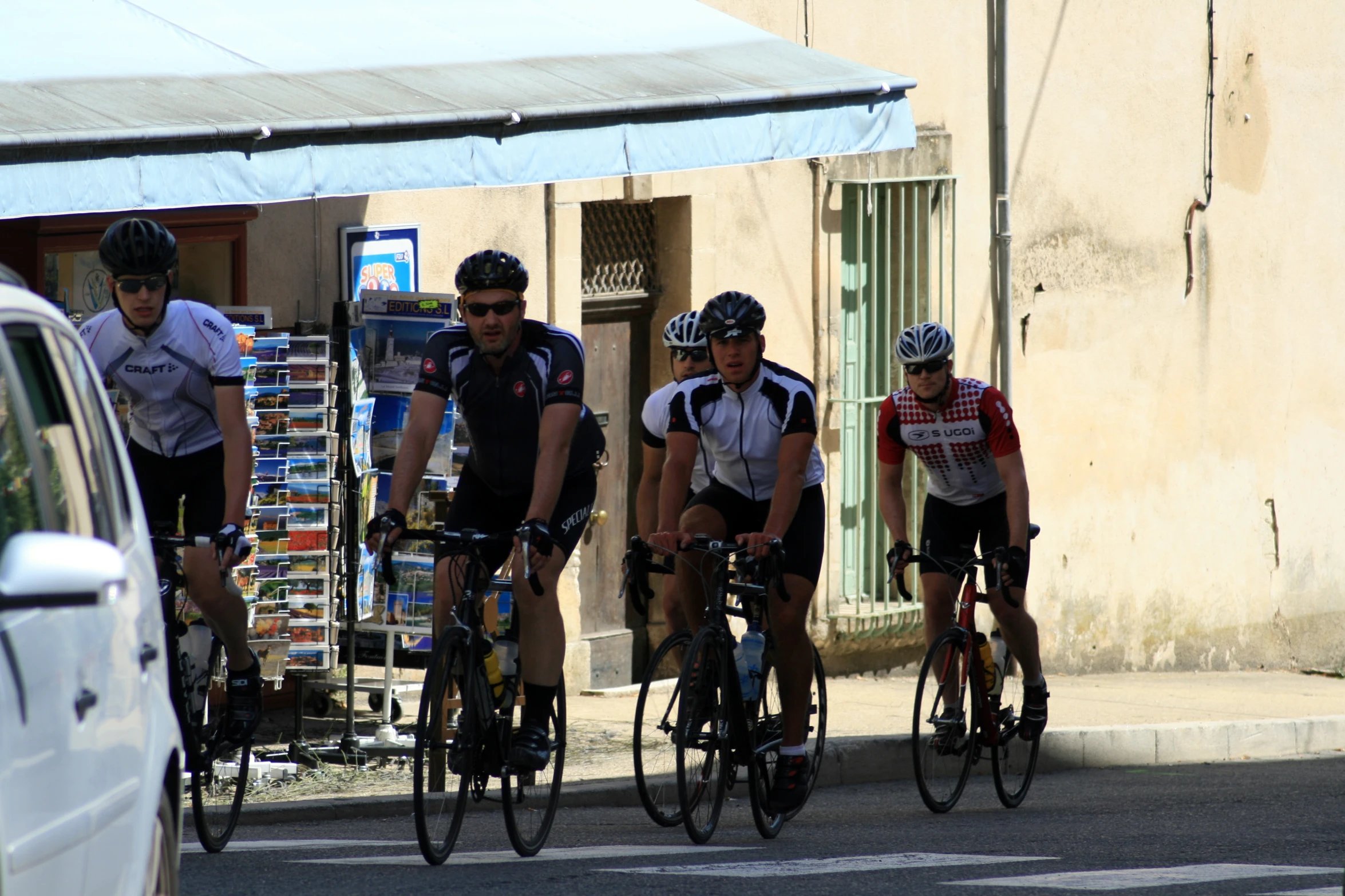 a group of men riding on bikes down a road