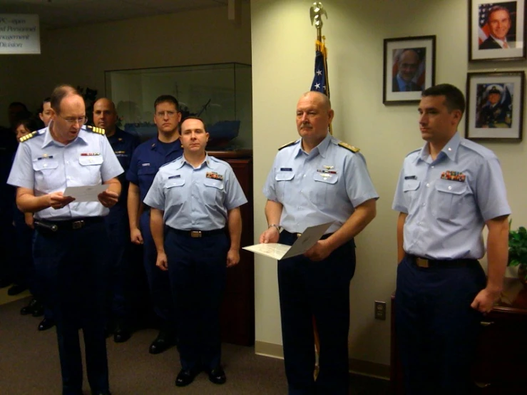 some military personnel are standing in a line