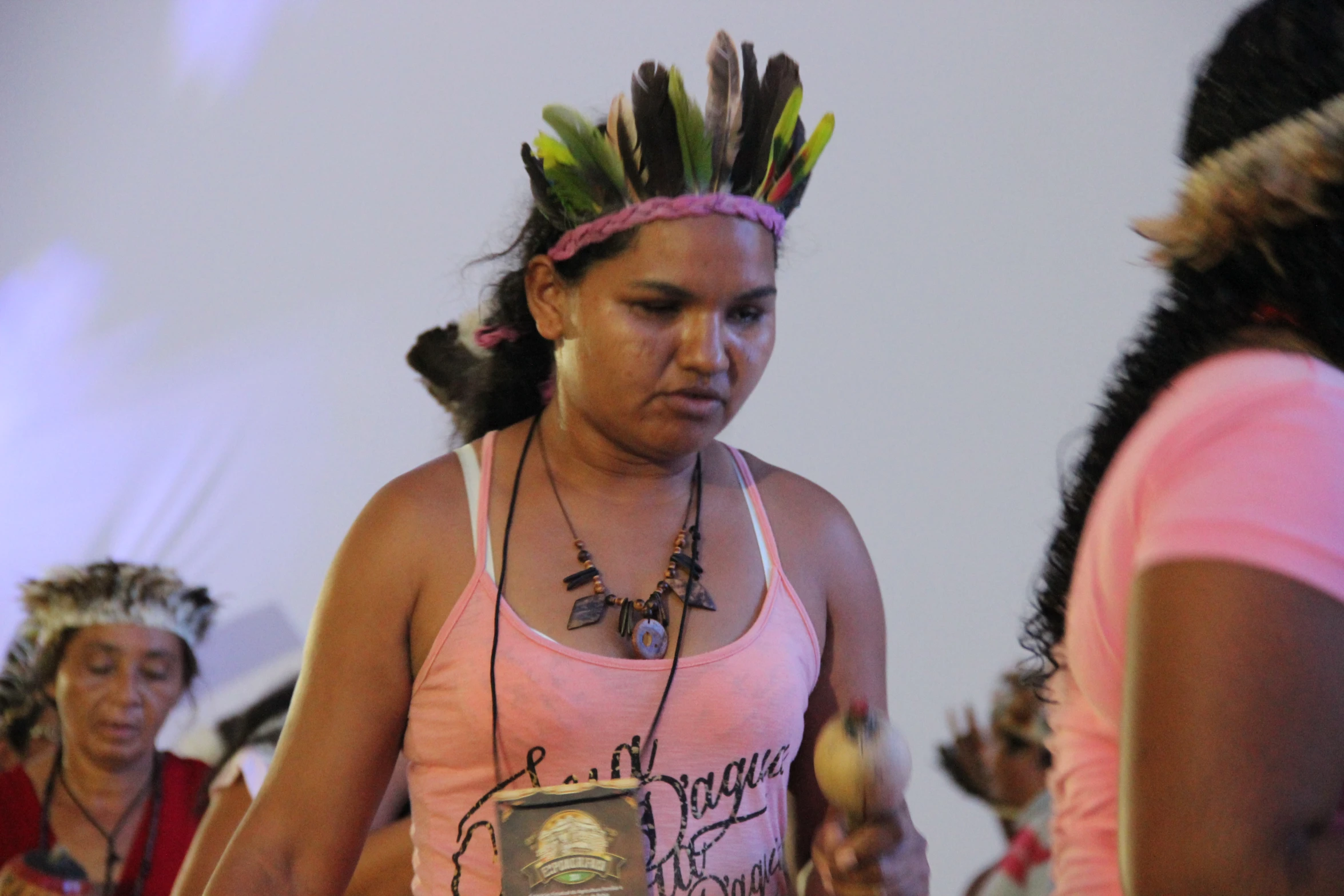 a native american woman wearing head gear with other people