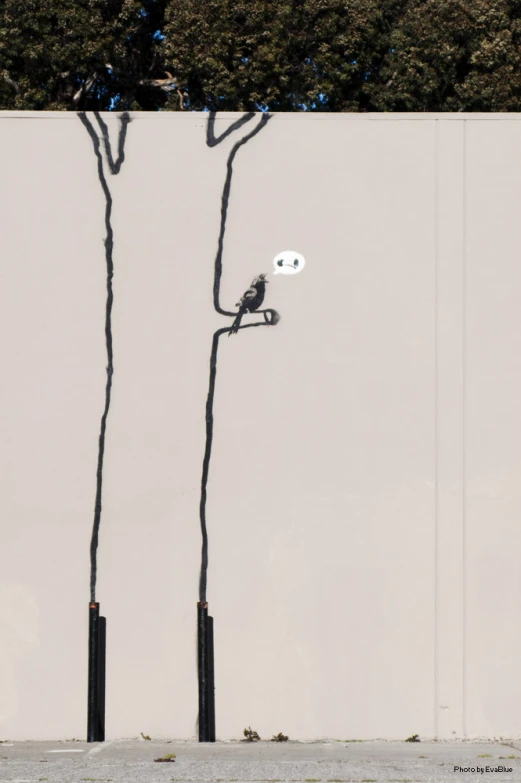 a drawing of two birds on a street light