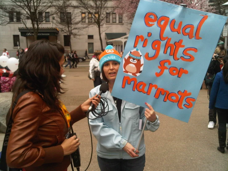 two women holding up a sign that says equal rights for marriage