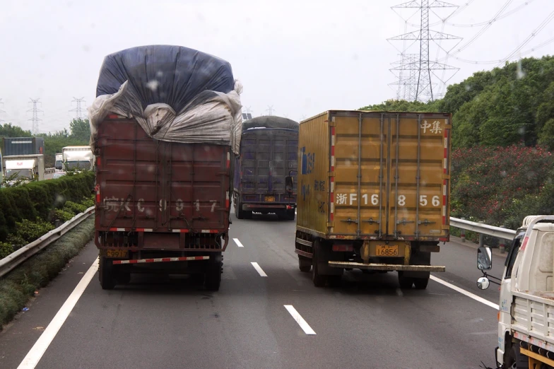 a couple of big trucks are going down the road