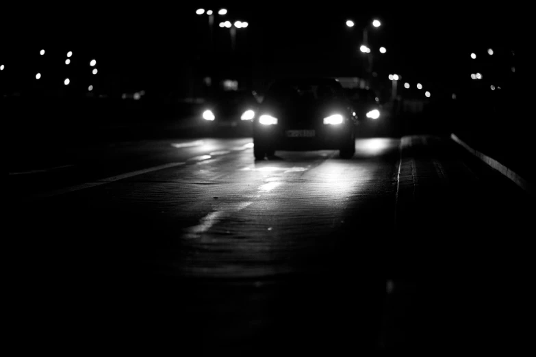 there are three cars that are moving in the dark