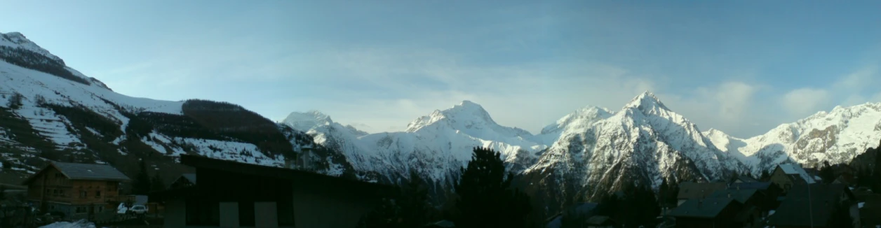 mountains covered in snow on the horizon of town