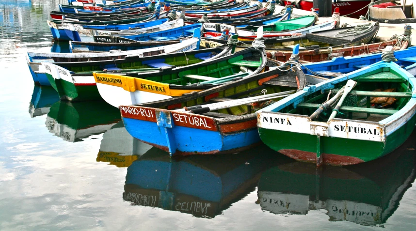 boats with names on them are sitting in the water