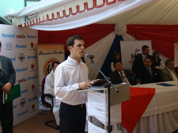 a man standing at a podium giving a speech