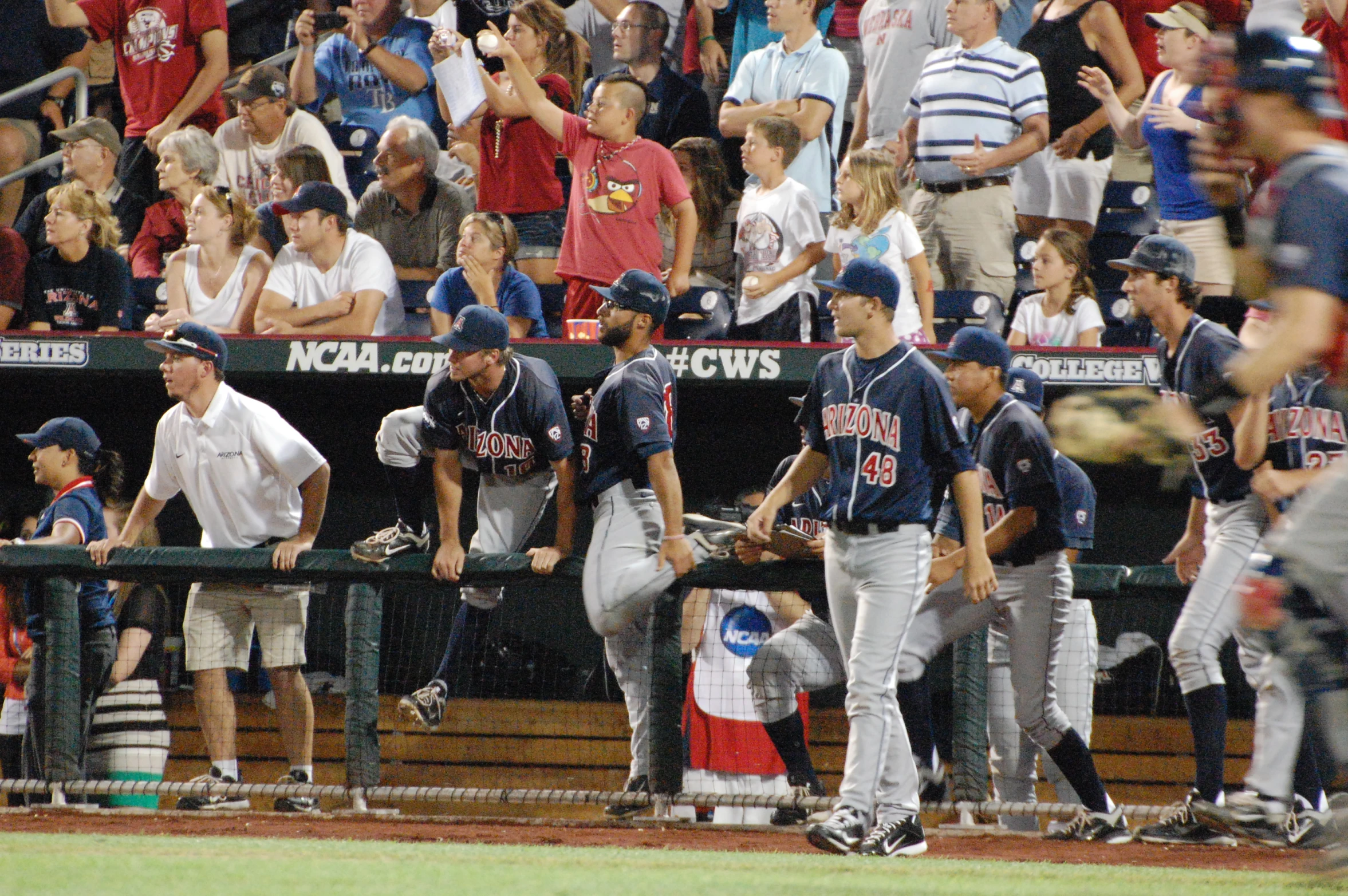 several baseball players sit at the dugout