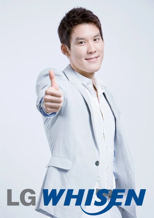 an asian man giving the thumbs up while wearing a gray suit