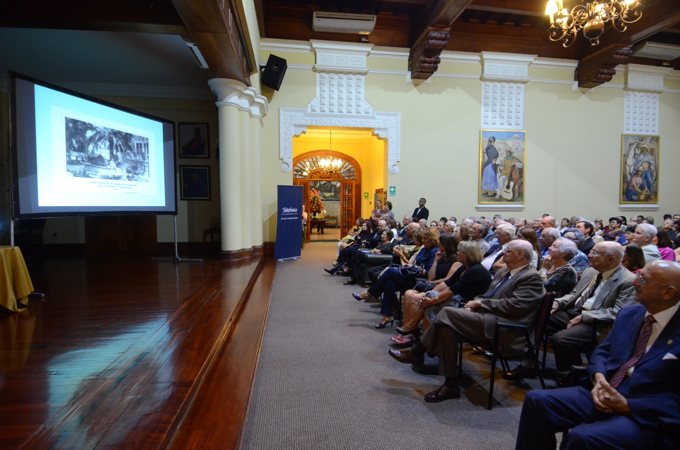 many people at the front of a room watching speakers