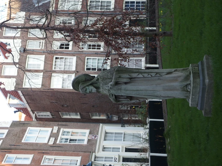 a statue standing in front of some buildings