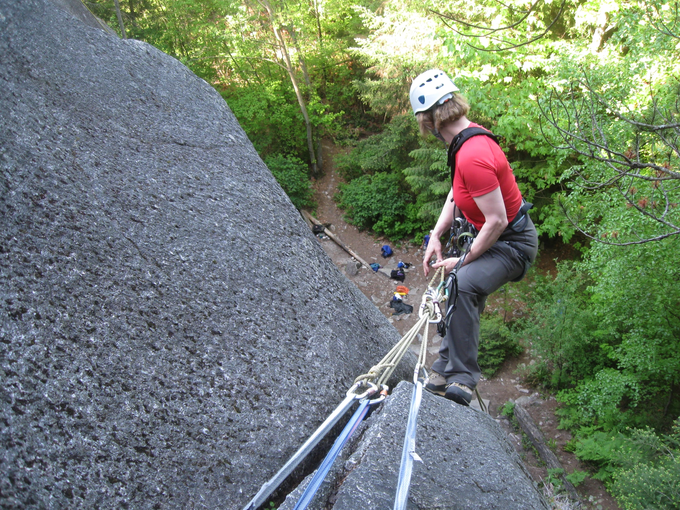 a man standing on top of a rock cliff