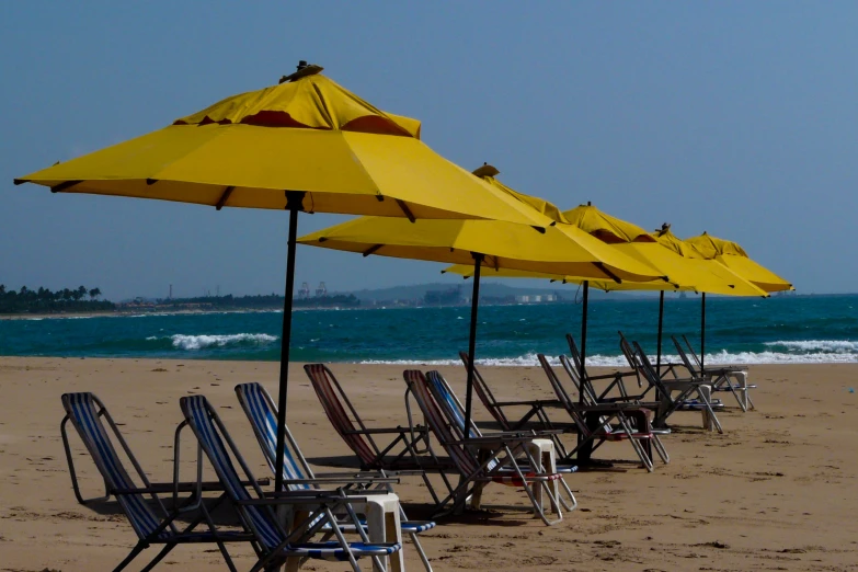 yellow umbrellas and lounge chairs on the beach