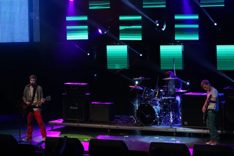 a group of people standing on a stage with a band