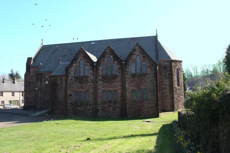 an old church sits on the grass by itself