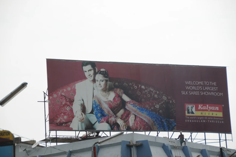 a billboard featuring two people on a large couch