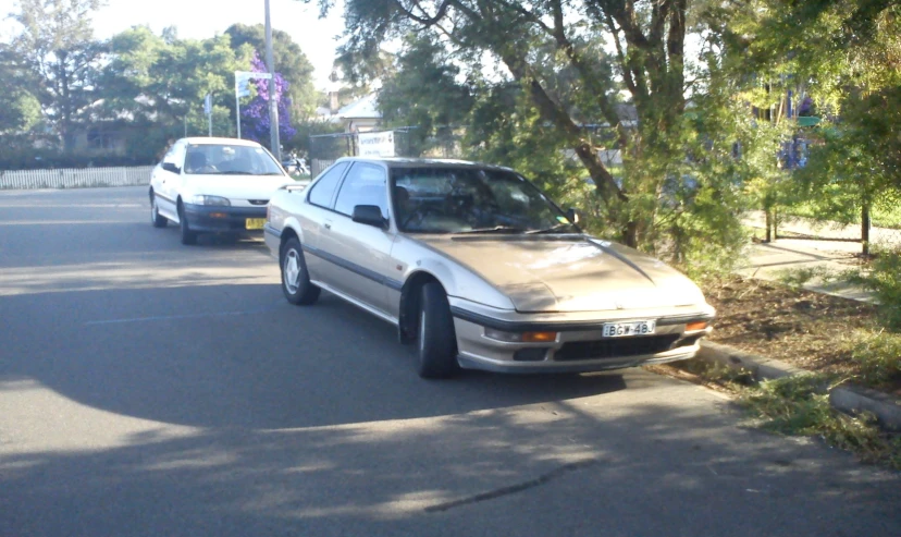 two cars are parked on the side of the road