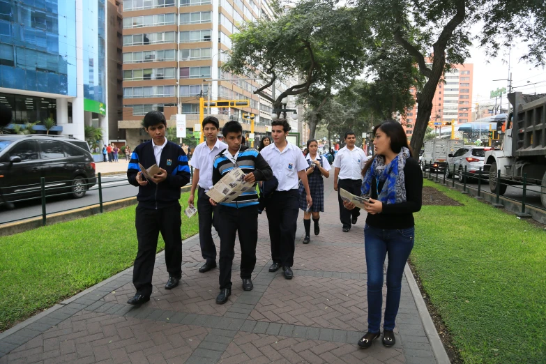 several students walking in the city with their back packs