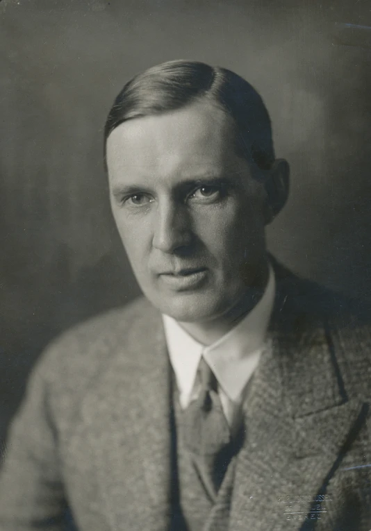 an old pograph of a man in a suit and tie