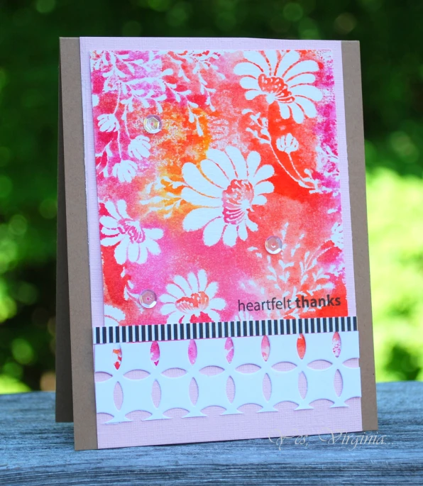 a card with a pink flower design