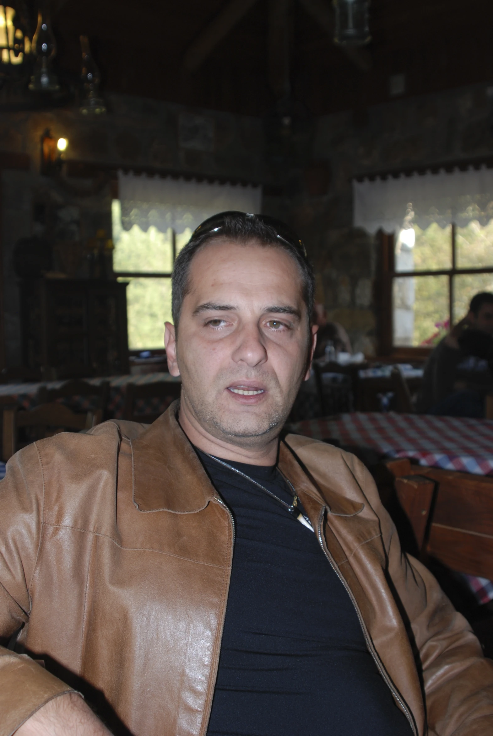 a man is looking over his shoulder in a restaurant