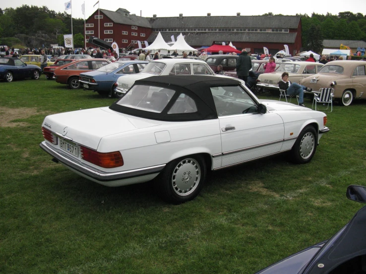 a bunch of cars parked on some grass