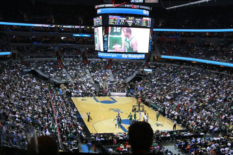 a view of a basketball arena, with fans sitting in seats