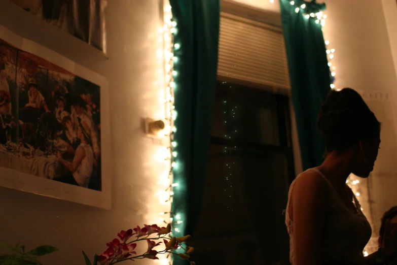 a woman standing in a room with lights on