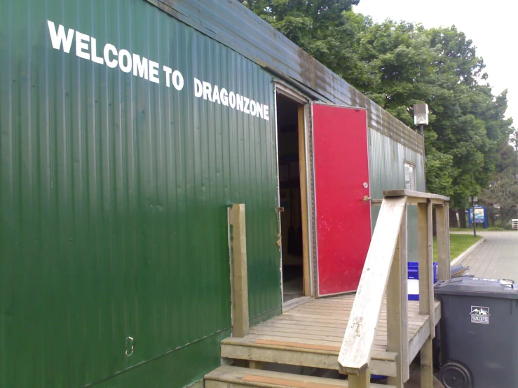 a welcome sign on a green cargo building