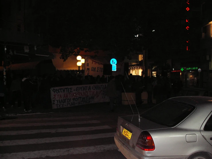 cars and people in a dark city street