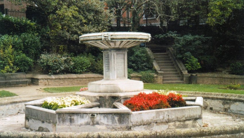 the stone water fountain has flowers on it