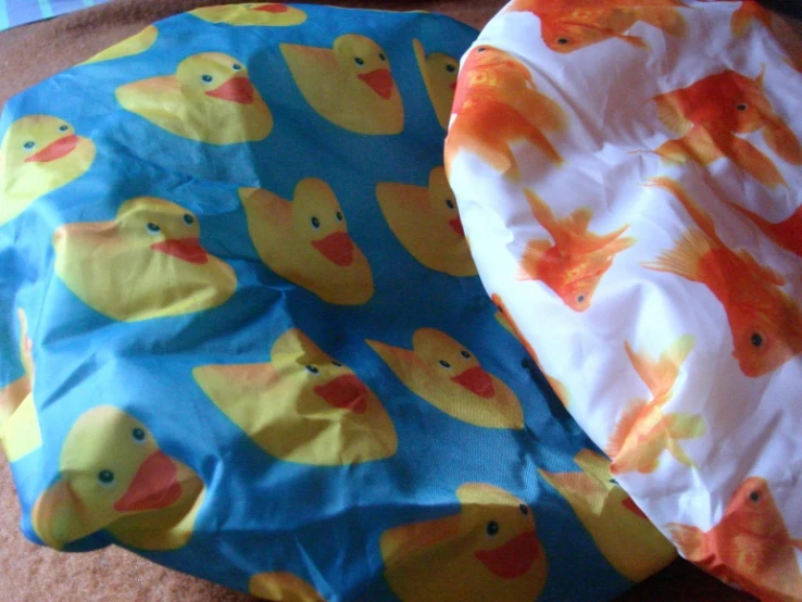 two baby blankets with colorful designs on them