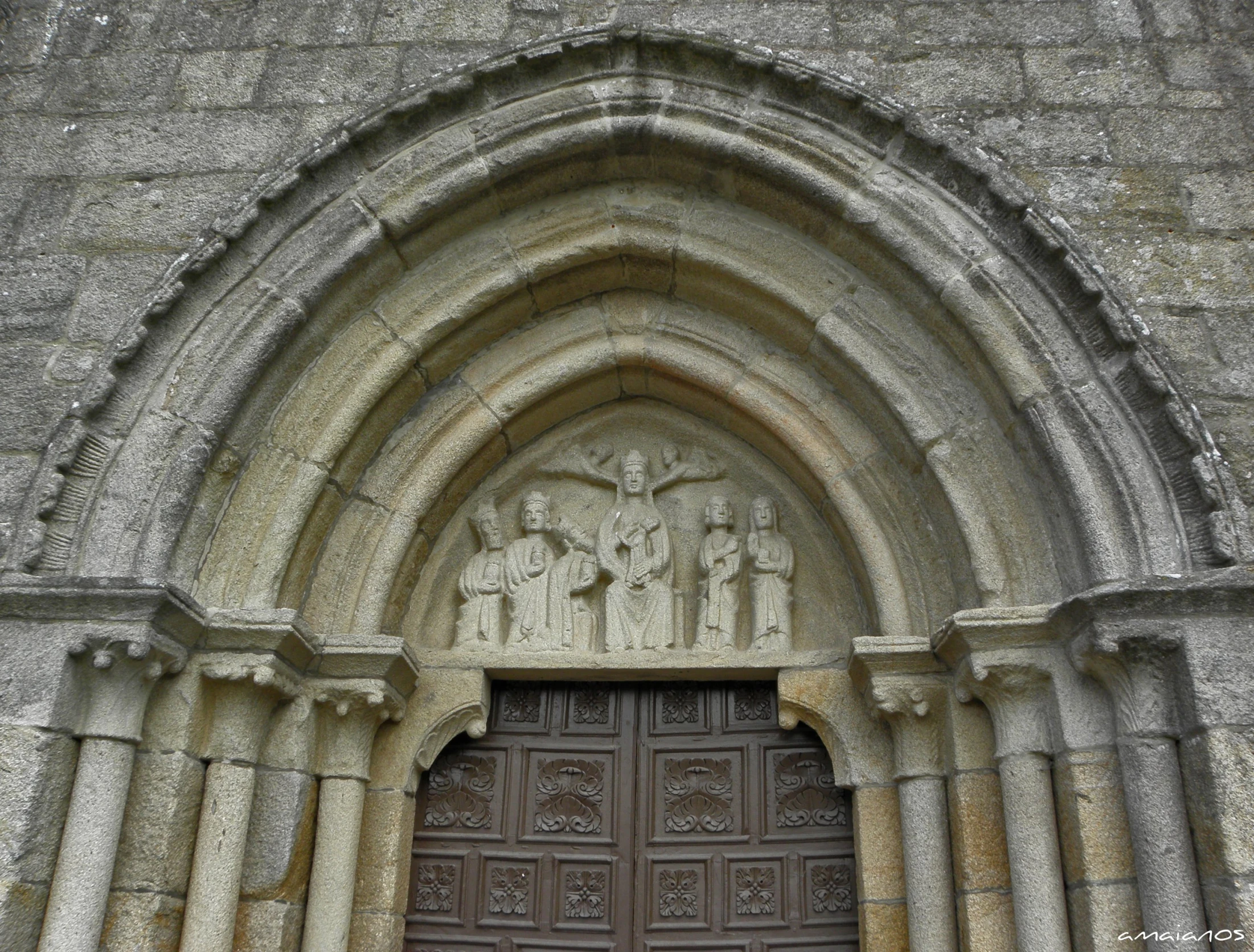 a door to an old building with carvings on the side