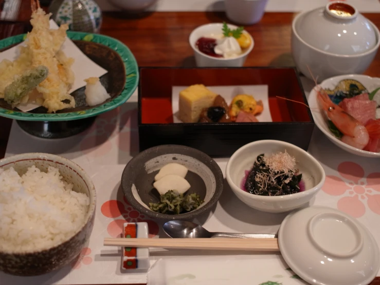 a table topped with bowls filled with different types of food