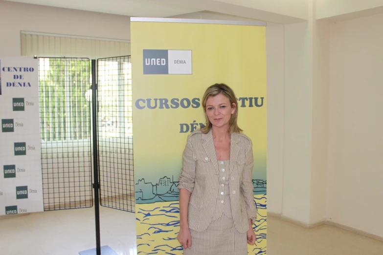 a woman standing next to a tall yellow sign