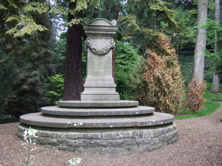 a garden with stone steps and a clock tower