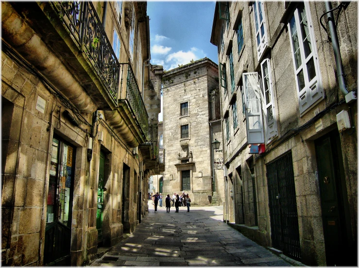 the stone buildings along this old street are very tall