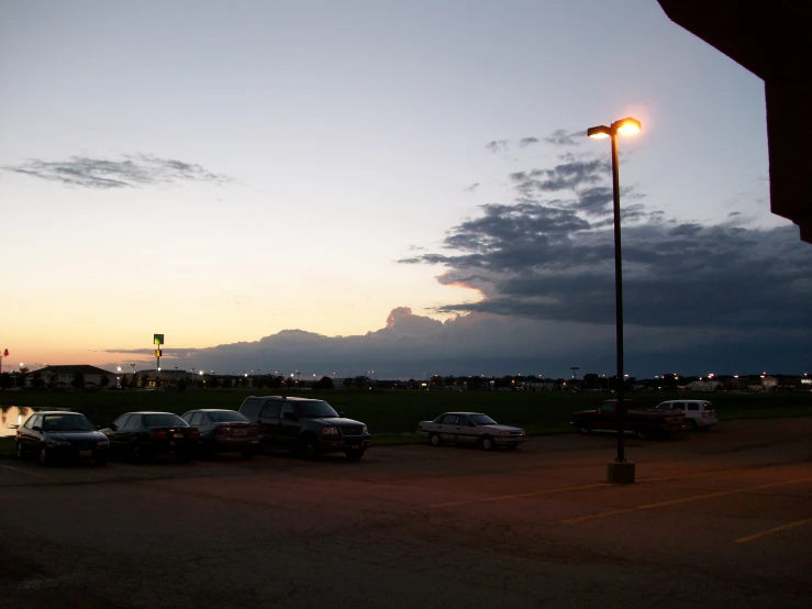 the street lights are on at the intersection in the parking lot