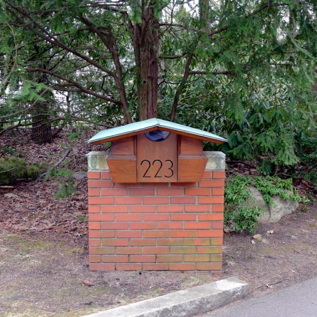 brick mailbox with the number 223 printed on it