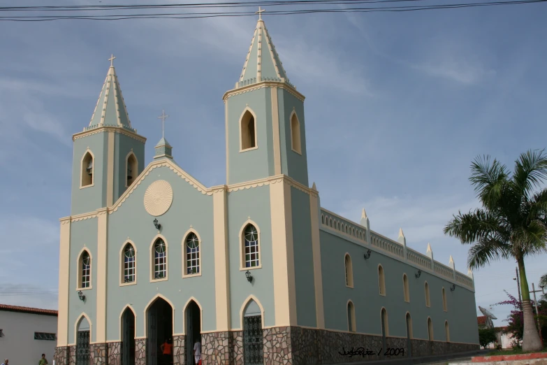 a blue building with a steeple and clock