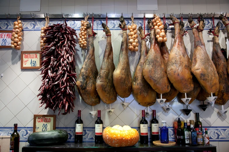 a couple of turkey hanging up next to some wine bottles