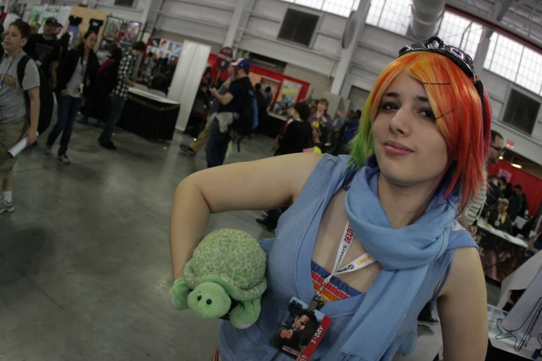 a person with red hair and a backpack with a green doll