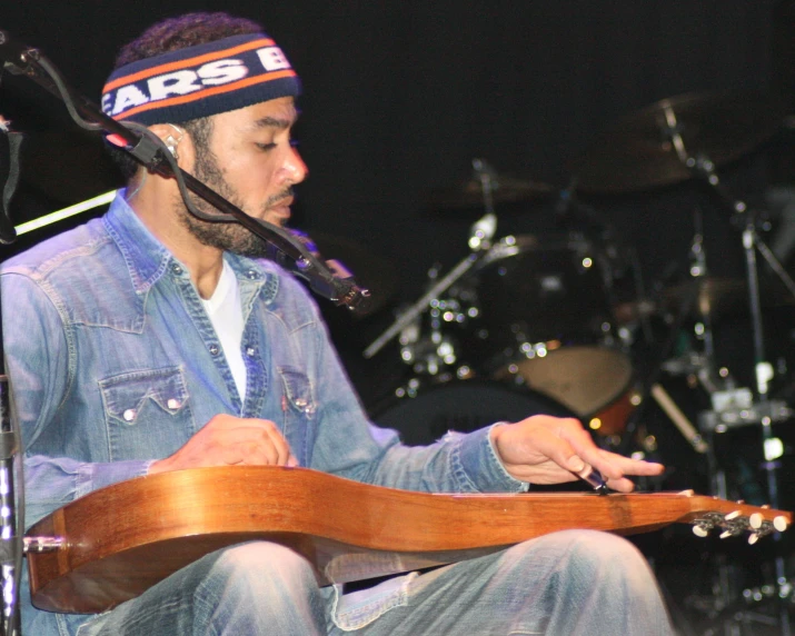 a man is playing a guitar and singing